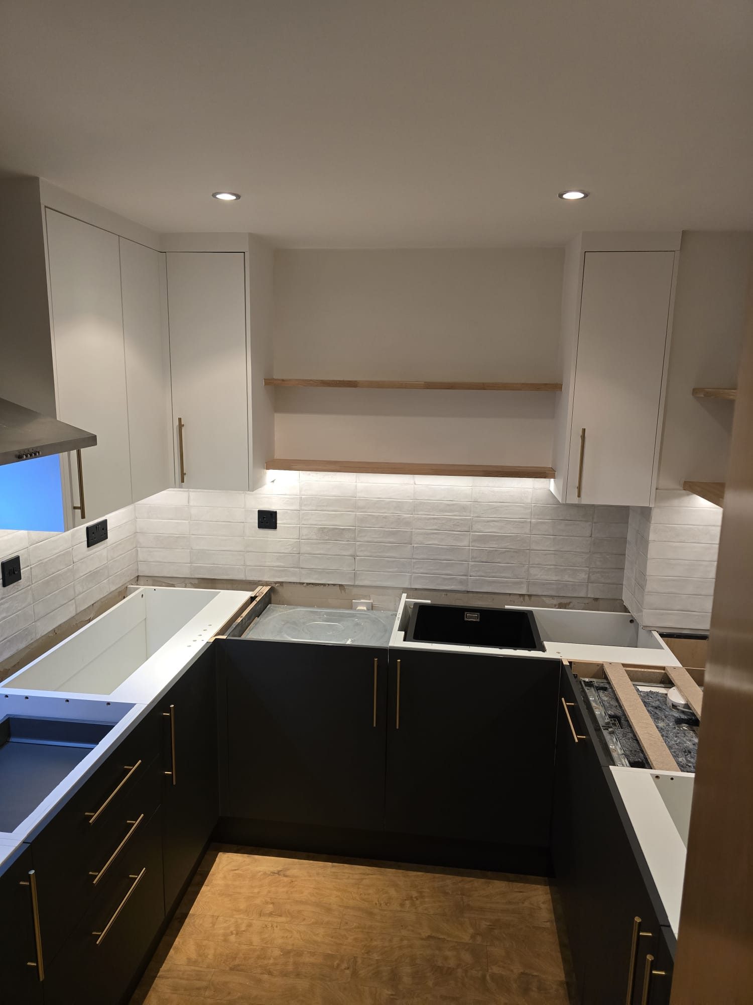 Kitchen work in progress with lighting and cabinets