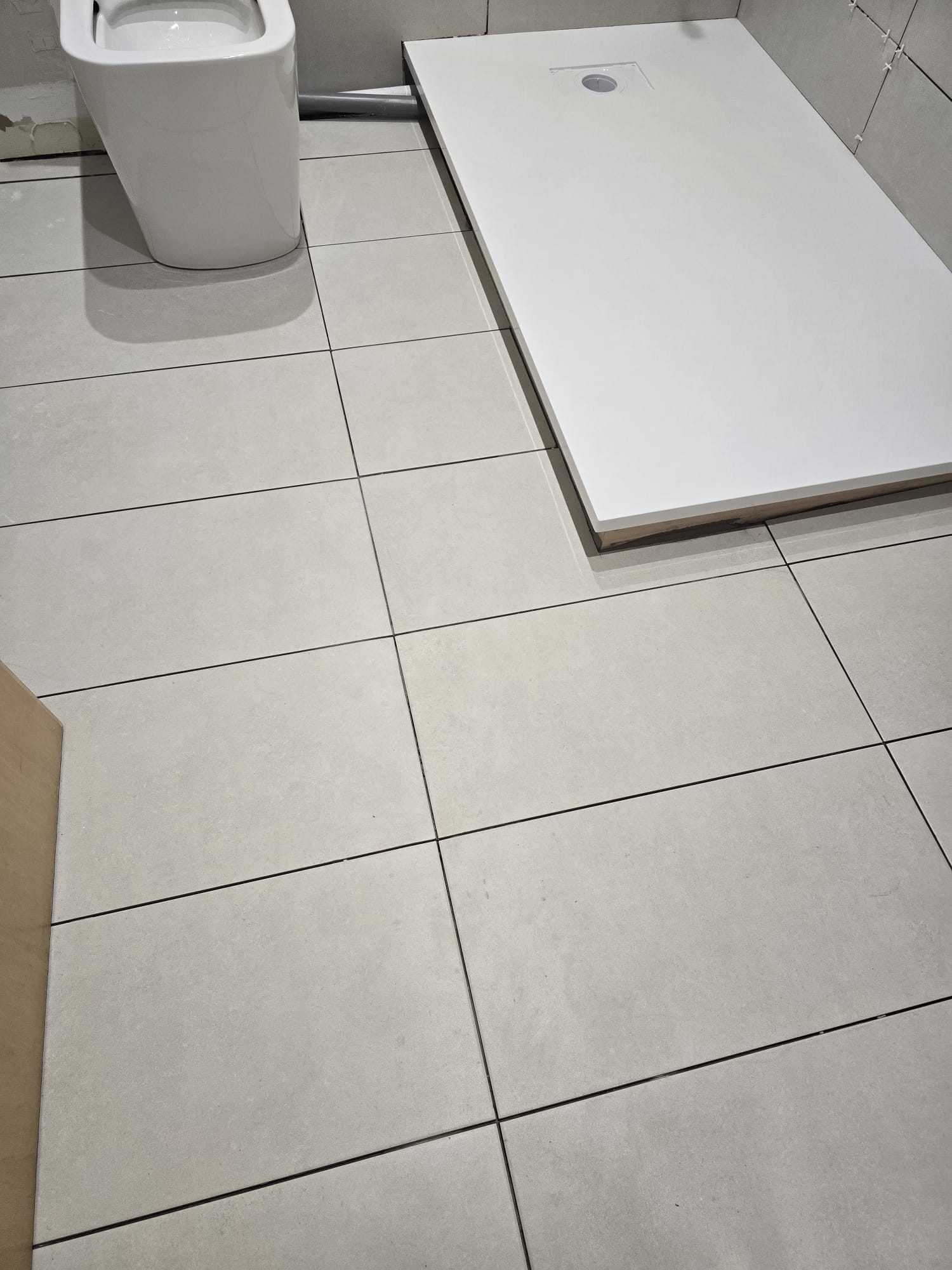 Bathroom floor tiling and shower tray in progress
