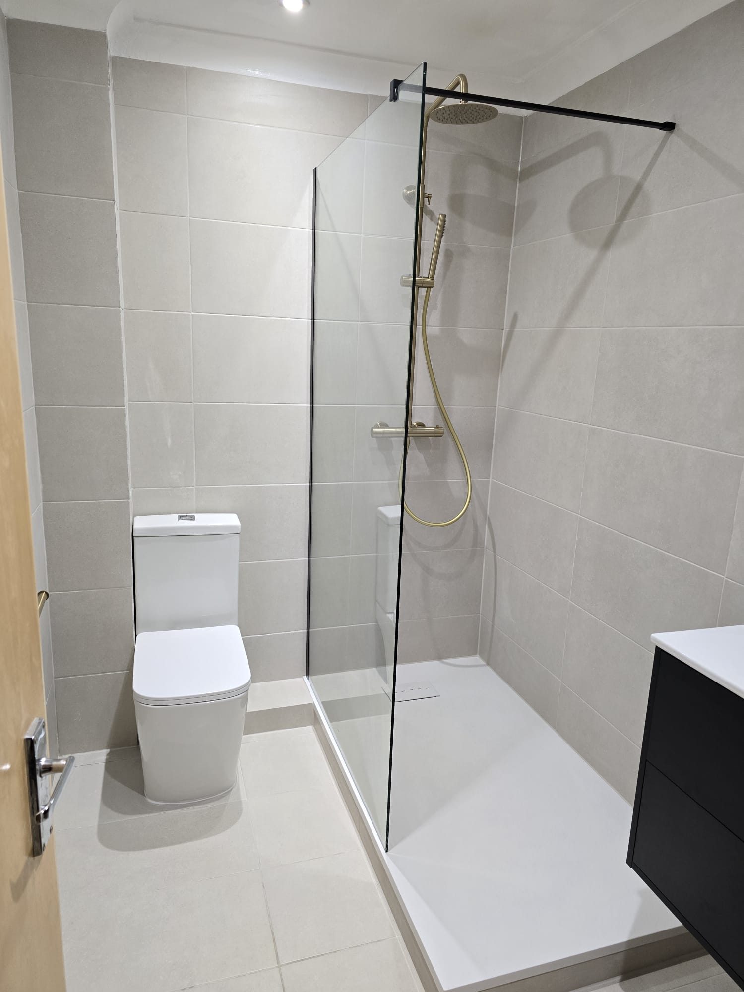 Completed bathroom refurbishment with walk-in shower