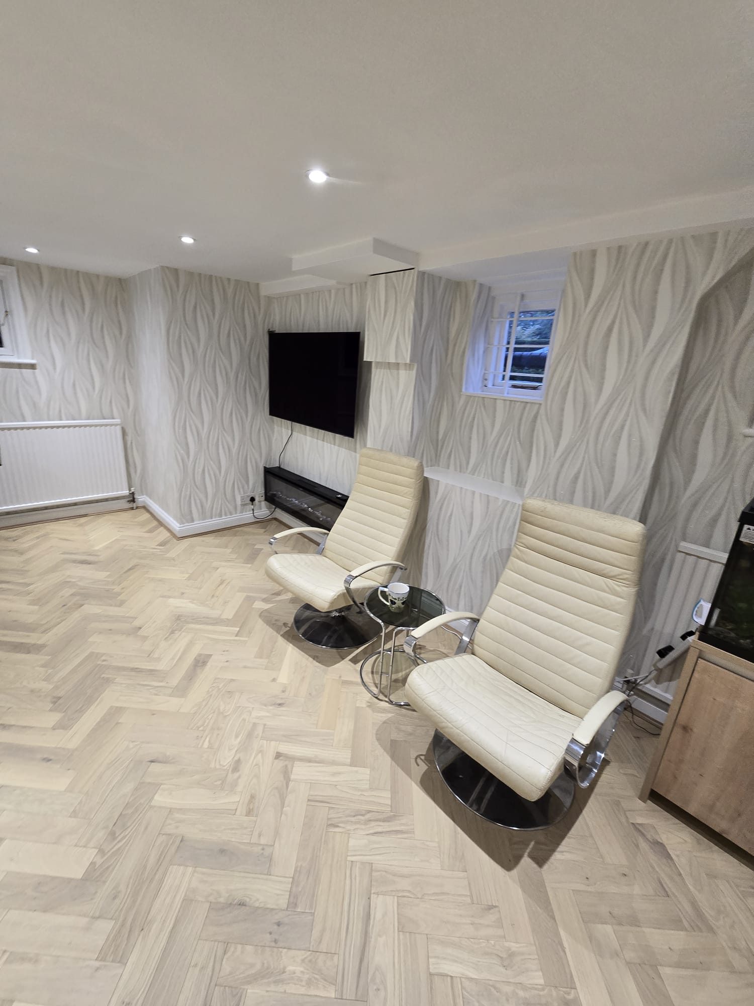 Finished living room with herringbone flooring